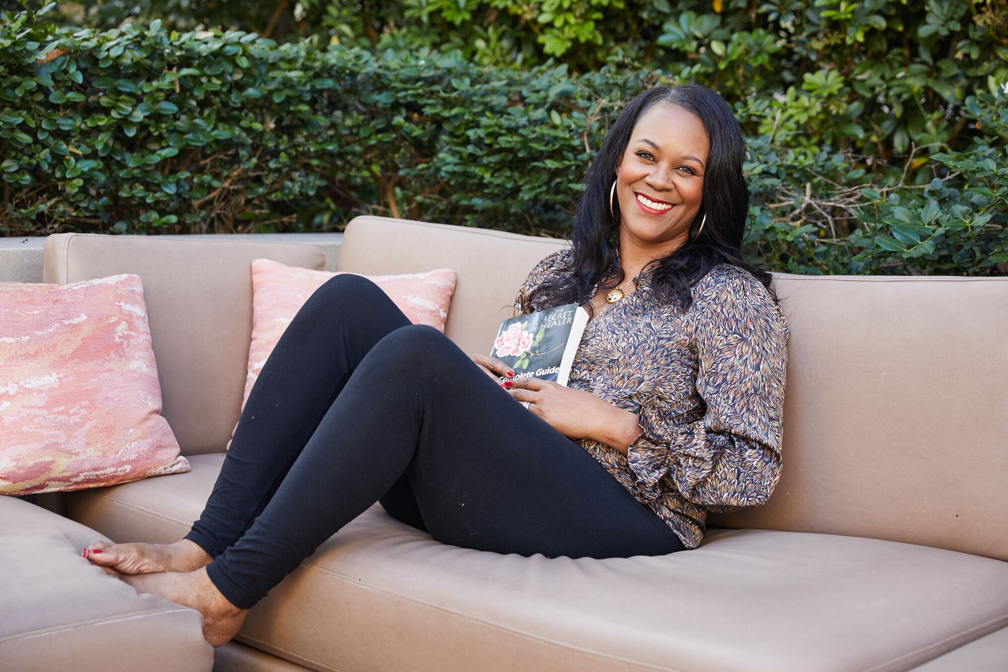 Debbie sitting on the outdoor couch